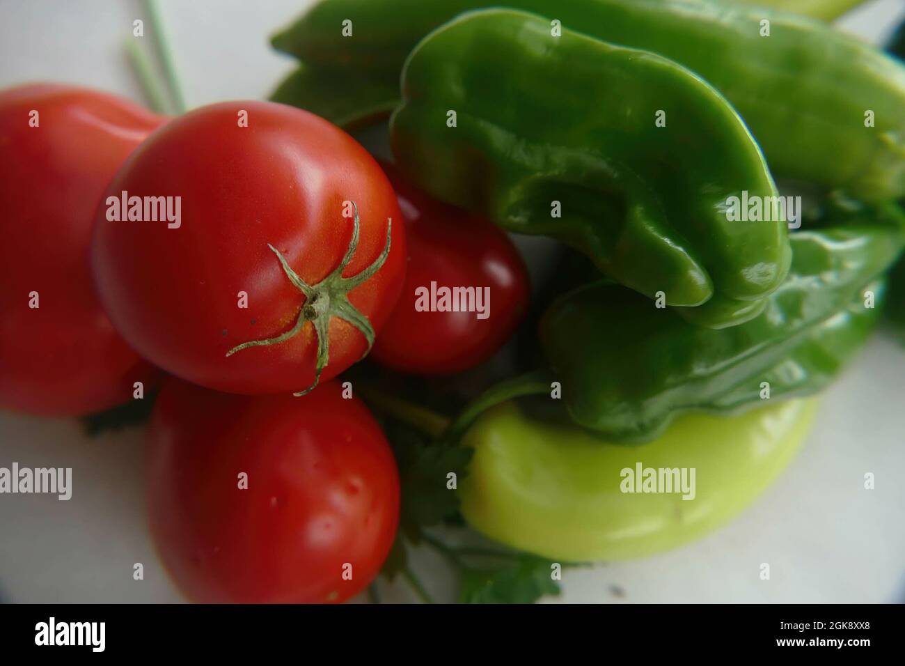 Fresh green peppers and tomatoes on white background Stock Photo - Alamy