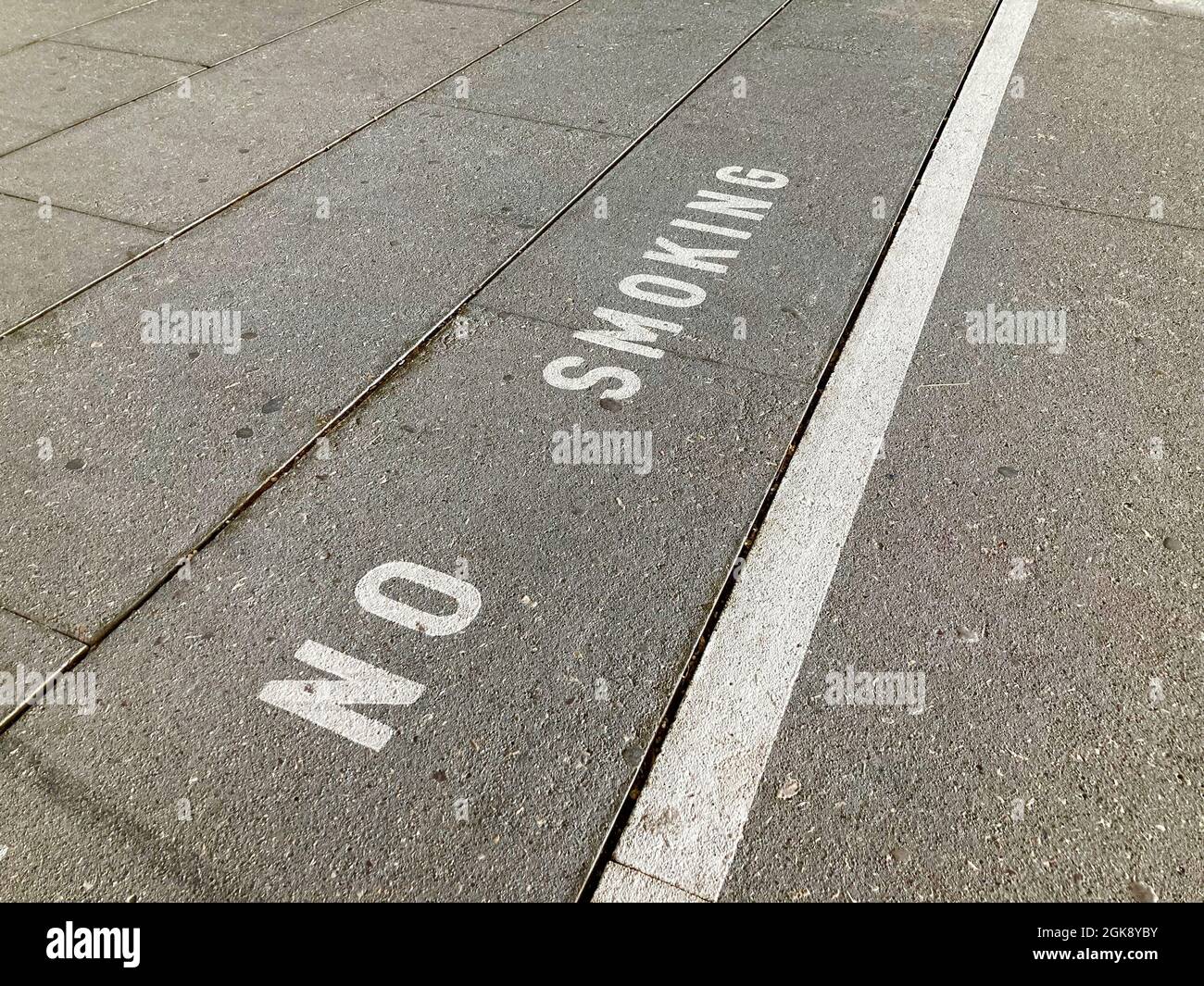 White No Smoking inscription on asphalt in Switzerland Stock Photo