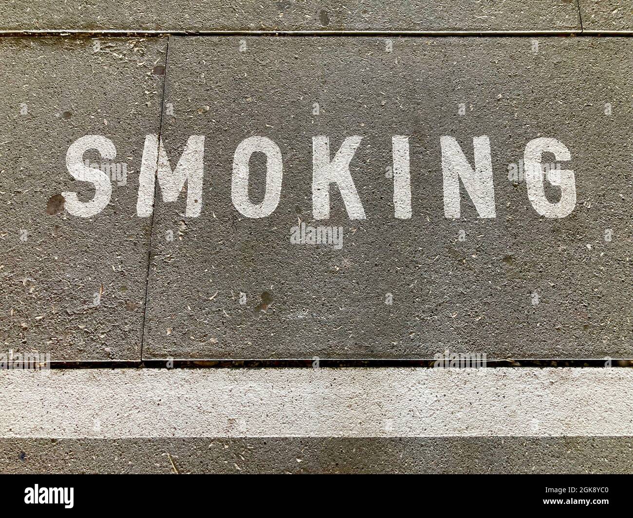 White Smoking inscription on asphalt in Switzerland Stock Photo