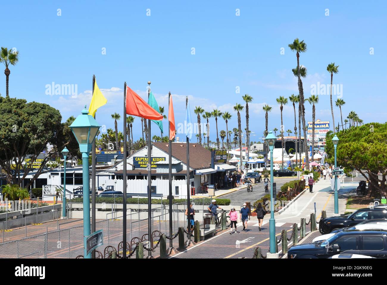REDONDO BEACH, CALIFORNIA - 10 SEP 2021: People stroll on the boardwalk in the Marina past shops and restaurants, Stock Photo