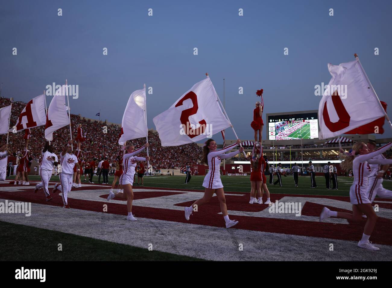 Bloomington, United States. 11th Sep, 2021. Indiana University cheerleaders carry flags after IU scores against Idaho during the NCAA football game at Memorial Stadium in Bloomington.The Hoosiers beat the Vandals 56-14. (Photo by Jeremy Hogan/SOPA Images/Sipa USA) Credit: Sipa USA/Alamy Live News Stock Photo