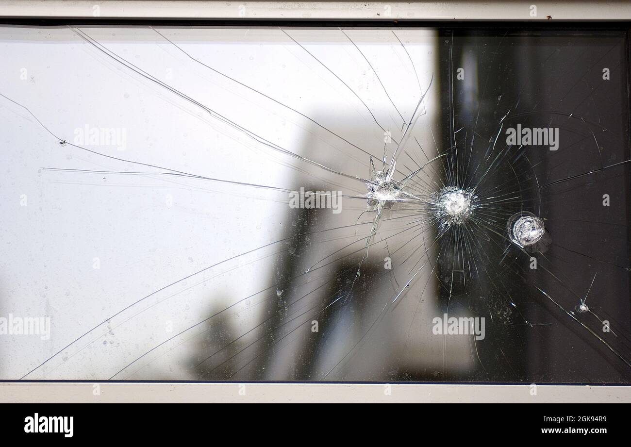 bullet holes in a glass panel Stock Photo