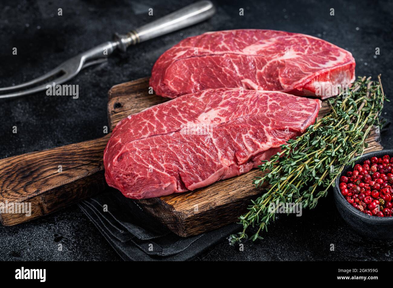 Fresh Raw Top Blade Or Flat Iron Beef Meat Steaks On A Butcher Cutting fresh-raw-top-blade-or-flat-iron-beef-meat-steaks-on-a-butcher-cutting