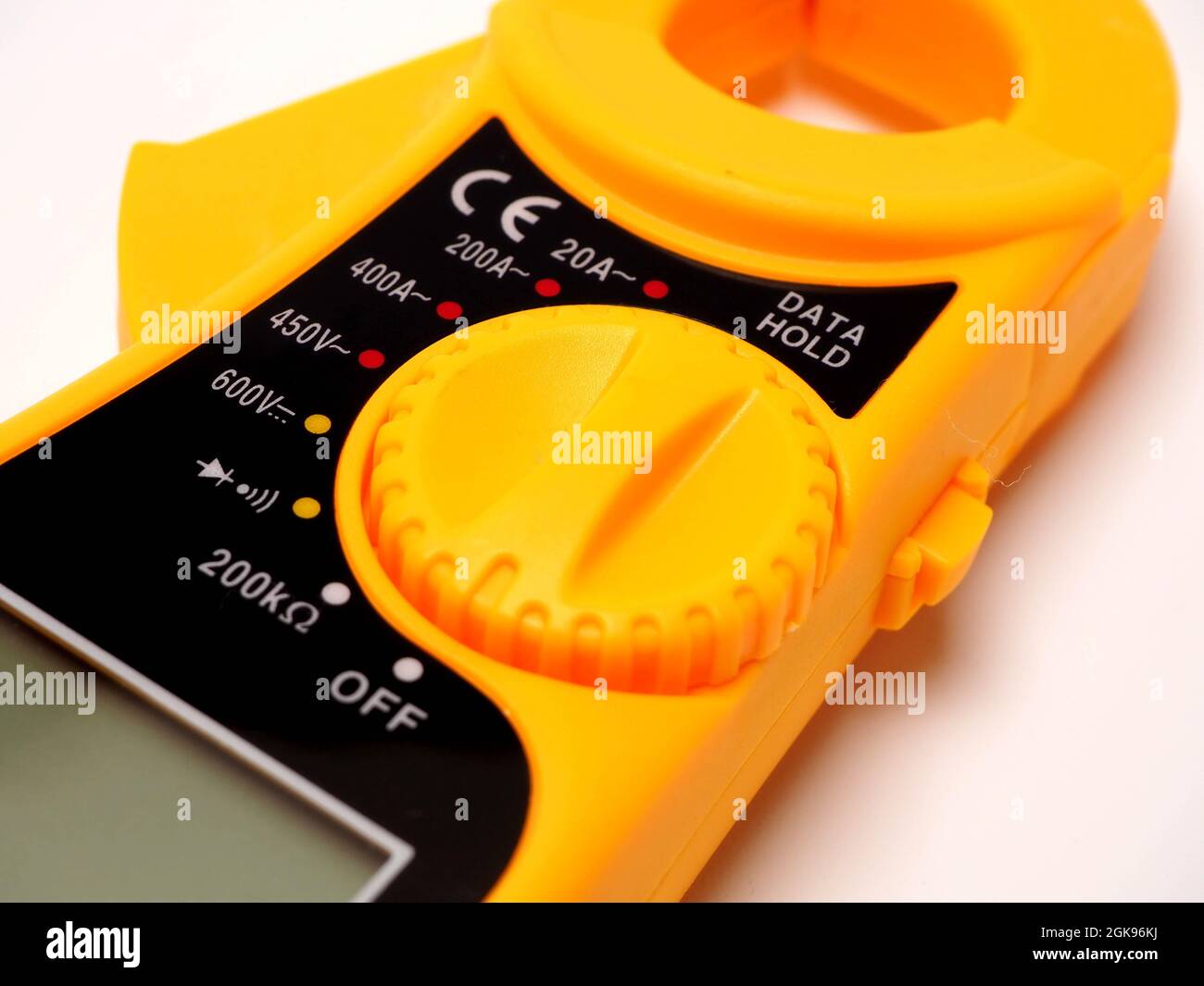 Picture of yellow digital clamp meter that using for measuring electrical current, voltage and resistance. Shoot on white isolated background. Stock Photo