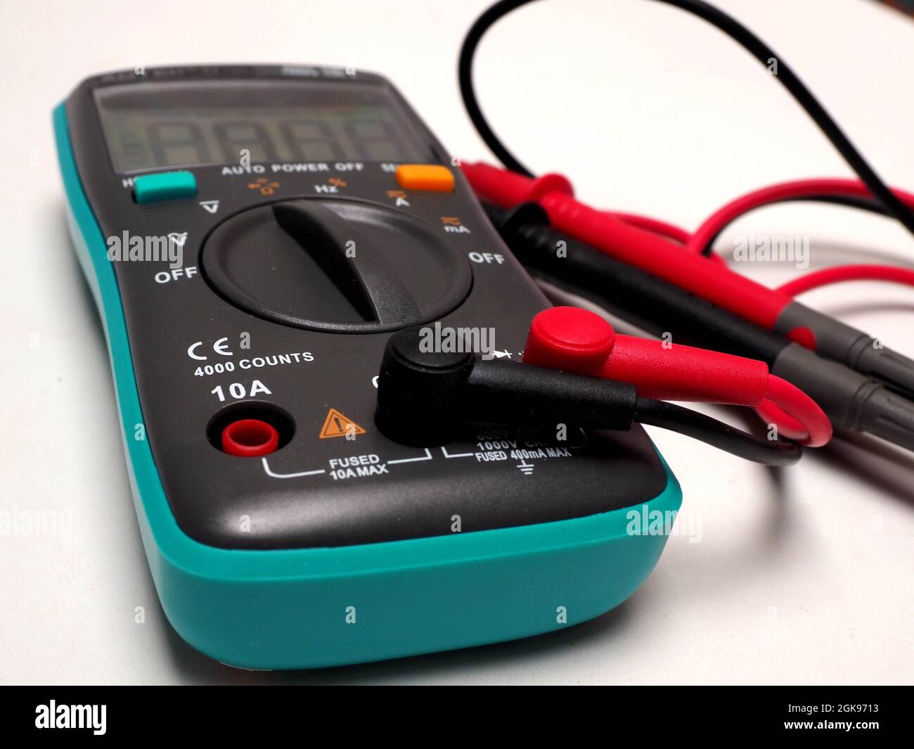 Picture of a digital multimeter, with red and black probe. Shoot on a