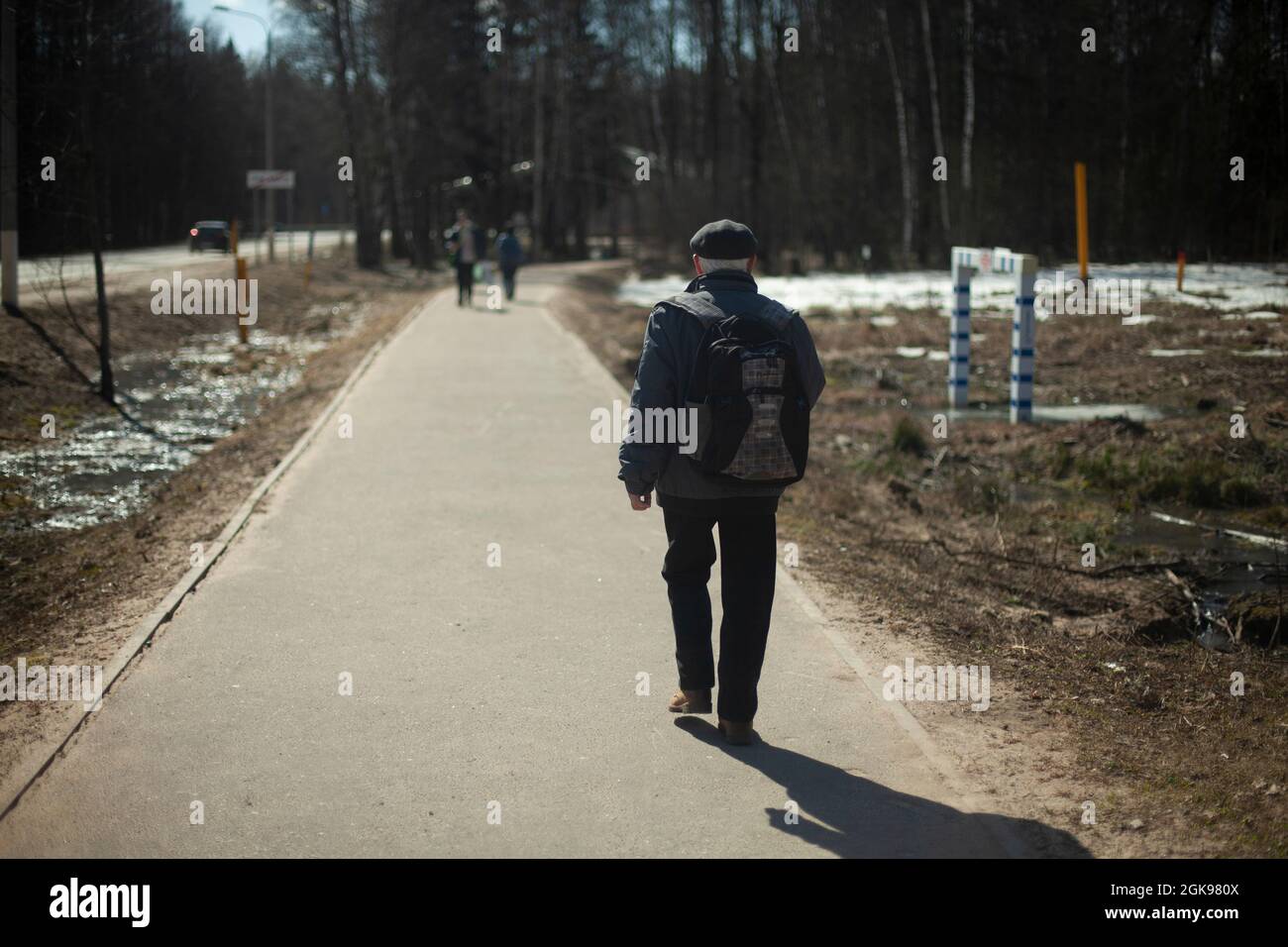 A man walks down the road in the park. A person in Russia steps to work. A simple  citizen Stock Photo - Alamy
