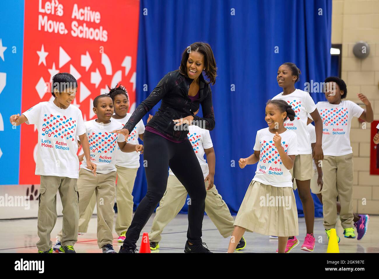 First Lady Michelle Obama participates in musical activities with students during a back to school 'Let's Move!' Active Schools event at Orr Elementary School in Washington, D.C., Sept. 6, 2013. (Official White House Photo by Chuck Kennedy) This official White House photograph is being made available only for publication by news organizations and/or for personal use printing by the subject(s) of the photograph. The photograph may not be manipulated in any way and may not be used in commercial or political materials, advertisements, emails, products, promotions that in any way suggests approval Stock Photo