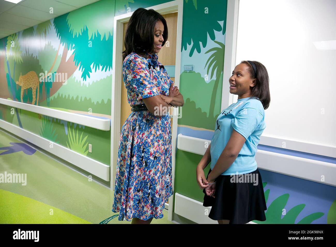 First Lady Michelle Obama talks with 10-year-old patient Courtney Davis before Davis introduces the First Lady to other patients at St. Jude Children's Research Hospital in Memphis, Tenn., Sept. 17, 2014. (Official White House Photo by Amanda Lucidon) This official White House photograph is being made available only for publication by news organizations and/or for personal use printing by the subject(s) of the photograph. The photograph may not be manipulated in any way and may not be used in commercial or political materials, advertisements, emails, products, promotions that in any way sugges Stock Photo