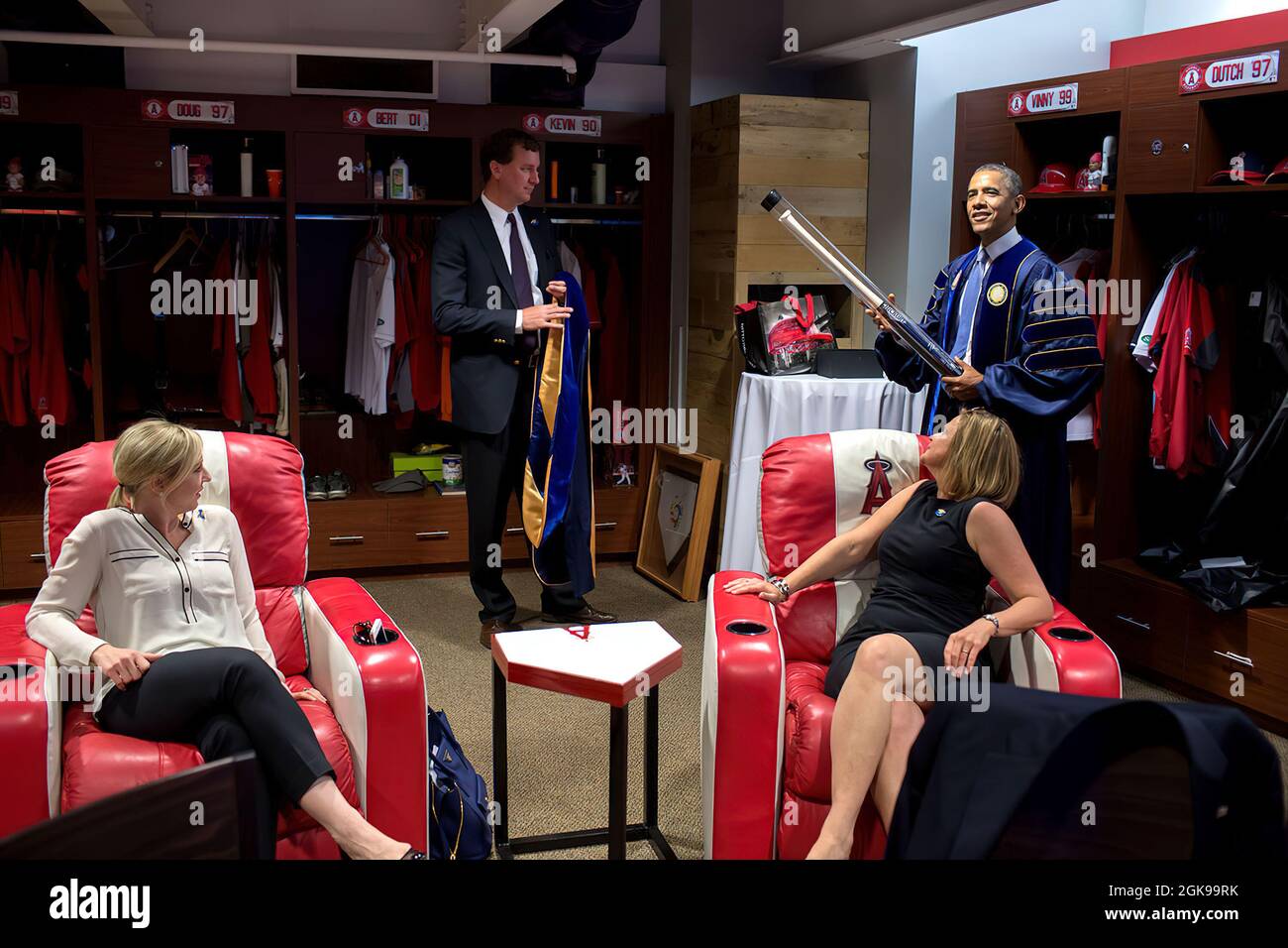 President Barack Obama holds a baseball bat  and jokes with staff in the locker room prior to the University of California, Irvine commencement ceremony at Angels Stadium of Anaheim in Anaheim, Calif., Saturday, June 14, 2014. From left are: Anita Decker Breckenridge, Deputy Chief of Staff for Operations, Trip Director Marvin Nicholson and Jennifer Palmieri, Director of Communications. (Official White House Photo by Pete Souza) This official White House photograph is being made available only for publication by news organizations and/or for personal use printing by the subject(s) of the photog Stock Photo
