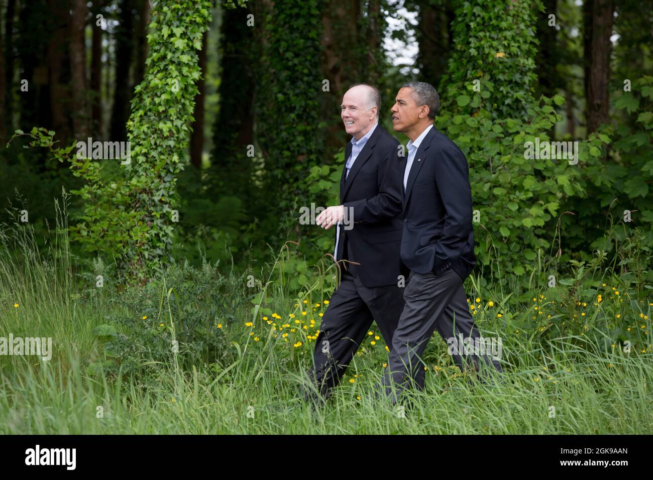 President Barack Obama walks with National Security Advisor Tom Donilon on the grounds of Lough Erne Resort at the conclusion of the G8 Summit in Enniskillen, Northern Ireland, June 18, 2013. (Official White House Photo by Pete Souza)  This official White House photograph is being made available only for publication by news organizations and/or for personal use printing by the subject(s) of the photograph. The photograph may not be manipulated in any way and may not be used in commercial or political materials, advertisements, emails, products, promotions that in any way suggests approval or e Stock Photo