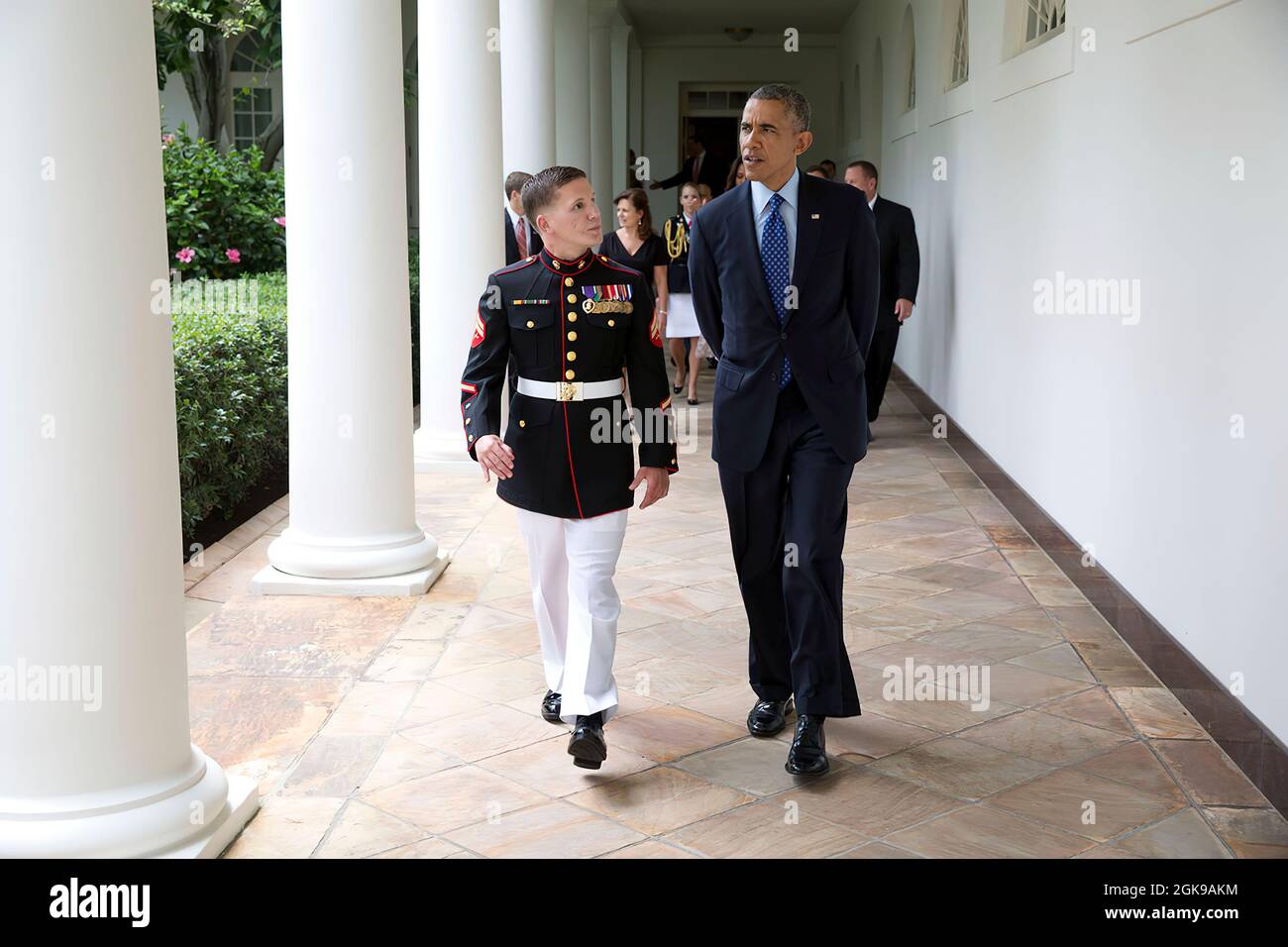 President Barack Obama walks on the Colonnade with Corporal William 'Kyle' Carpenter, U.S. Marine Corps (Ret.) en route to a Medal of Honor ceremony in the East Room of the White House, June 19, 2014. (Official White House Photo by Pete Souza) This official White House photograph is being made available only for publication by news organizations and/or for personal use printing by the subject(s) of the photograph. The photograph may not be manipulated in any way and may not be used in commercial or political materials, advertisements, emails, products, promotions that in any way suggests appro Stock Photo
