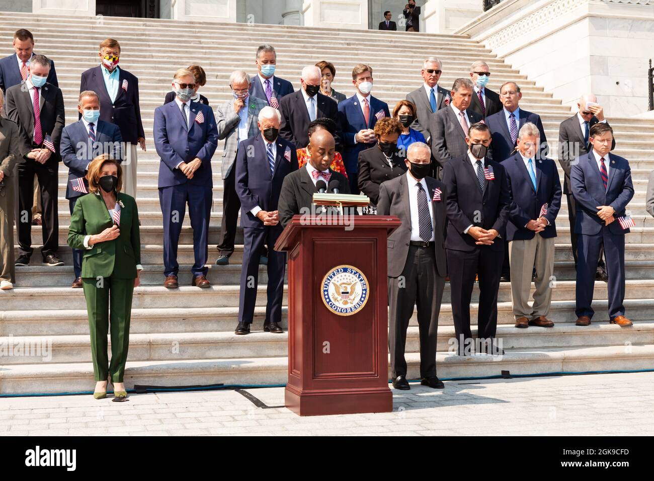 Washington DC, USA. 13th Sep 2021. Members of Congress bow their heads in prayer during a ceremony on the Capitol steps in remembrance of the victims of the September 11th attacks. Credit: Allison Bailey/Alamy Live News Stock Photo