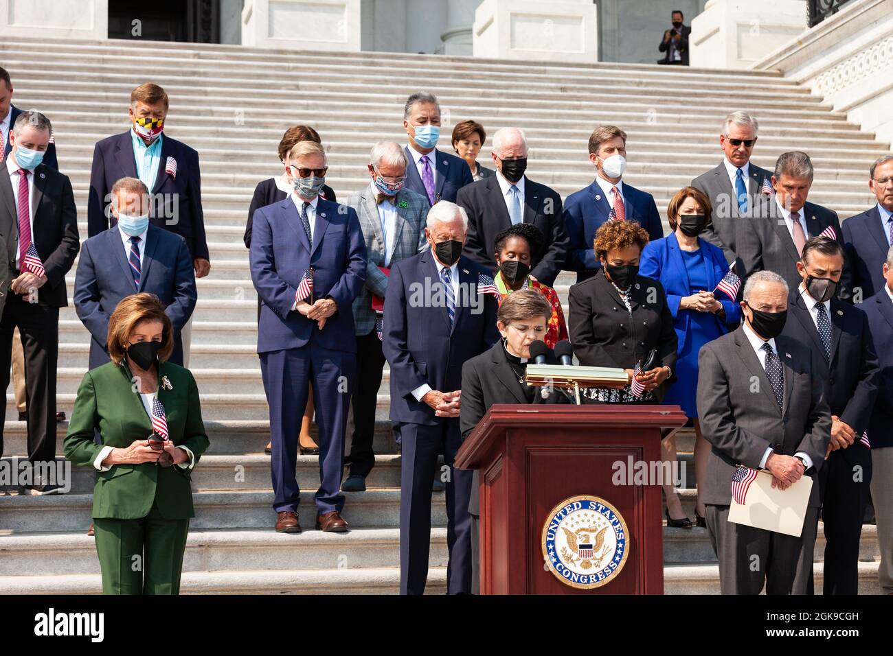 Washington DC, USA. 13th Sep 2021. Members of Congress bow their heads in prayer during a ceremony on the Capitol steps in remembrance of the victims of the September 11th attacks. Credit: Allison Bailey/Alamy Live News Stock Photo