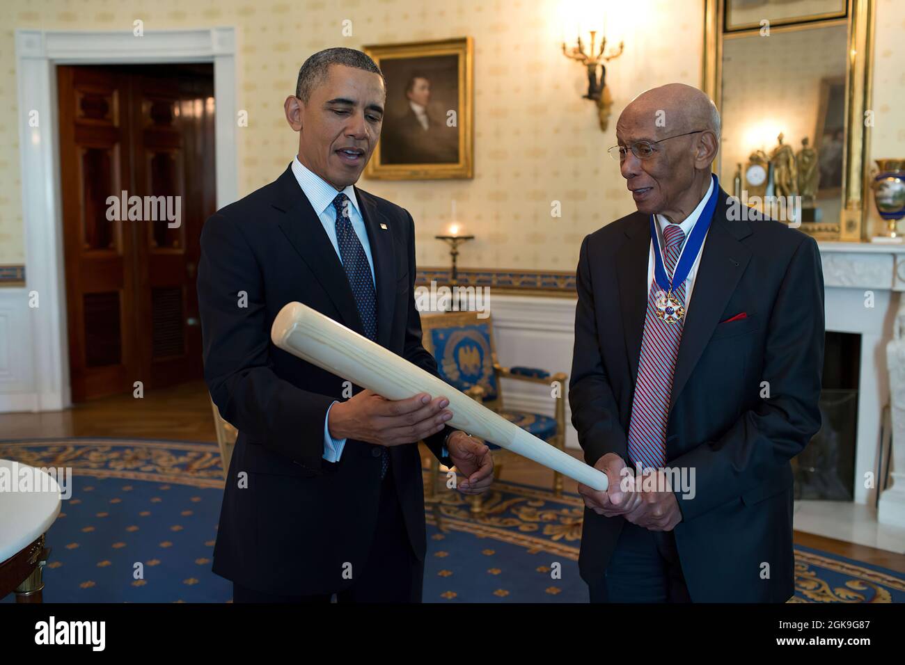 President Barack Obama talks with Ernie Banks, 2013 Presidential Medal of Freedom honoree, in the Blue Room the White House, Nov. 20, 2013.  (Official White House Photo by Pete Souza) This official White House photograph is being made available only for publication by news organizations and/or for personal use printing by the subject(s) of the photograph. The photograph may not be manipulated in any way and may not be used in commercial or political materials, advertisements, emails, products, promotions that in any way suggests approval or endorsement of the President, the First Family, or th Stock Photo