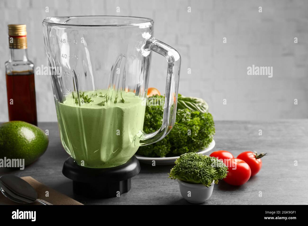 Creamy avocado sauce for fish taco in blender on kitchen table Stock