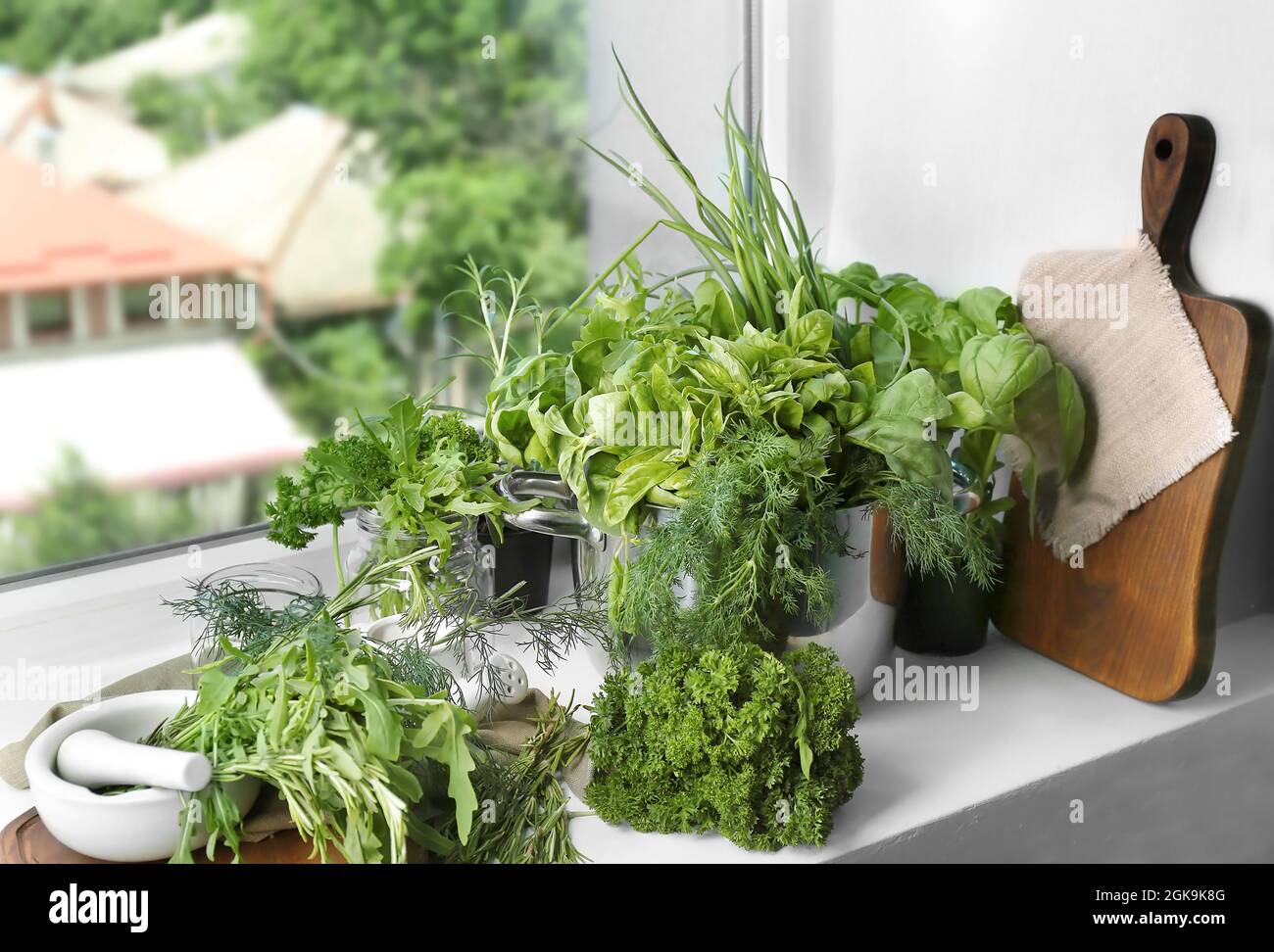 Variety of fresh herbs on windowsill Stock Photo - Alamy