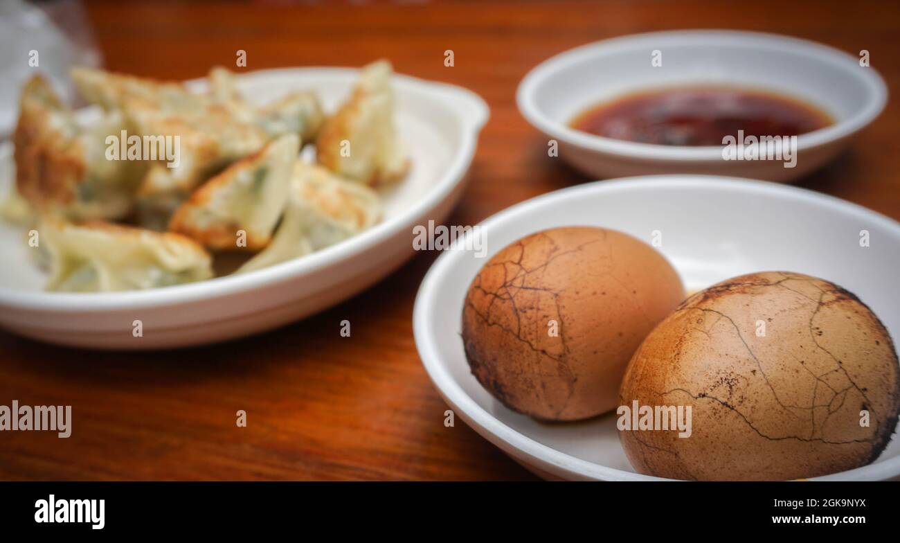 Traditional Chinese breakfast with tea eggs, pan fried dumpling