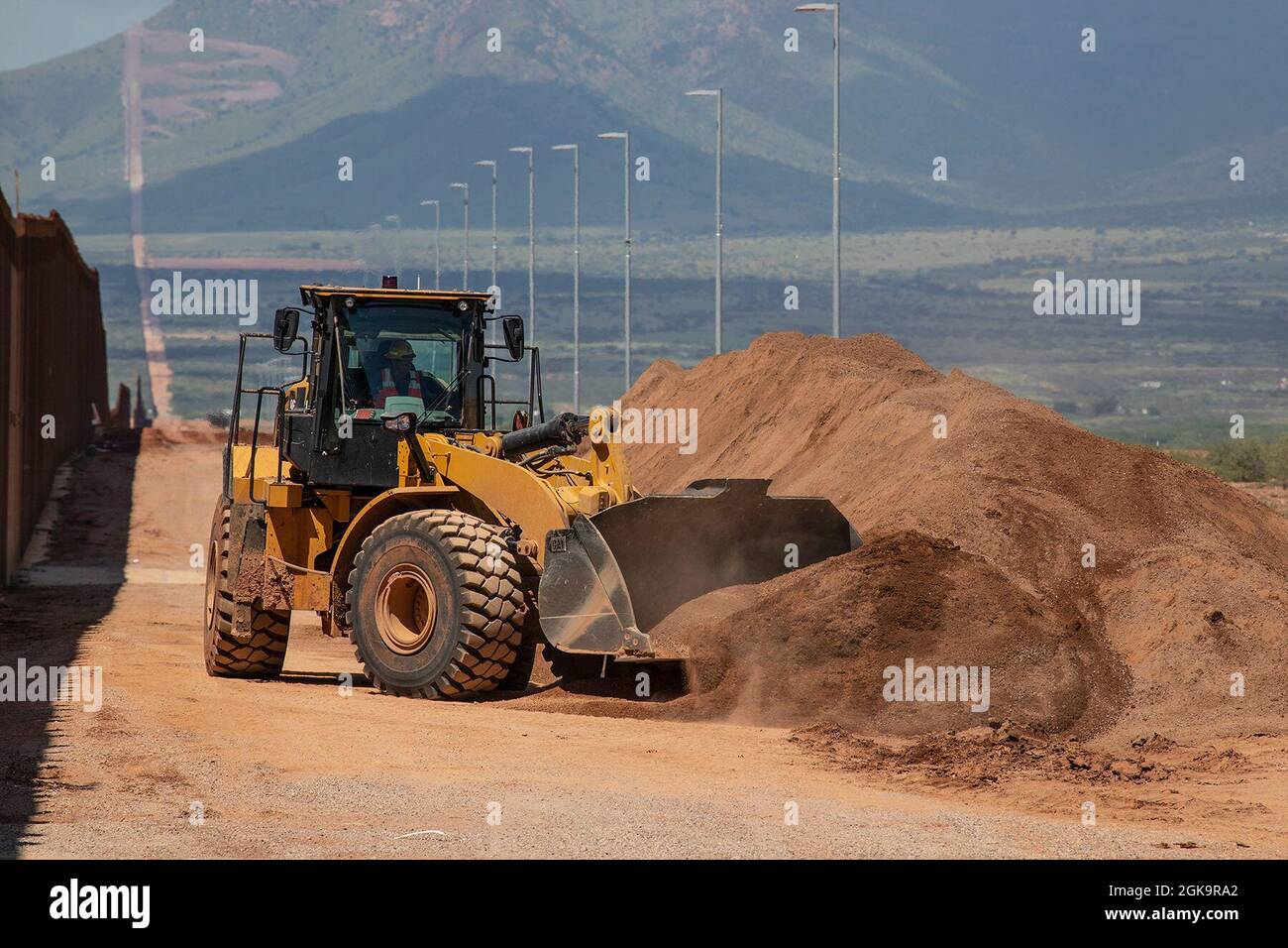 U.S. Army Corps of Engineers South Pacific Border District contractor fills an open trench at