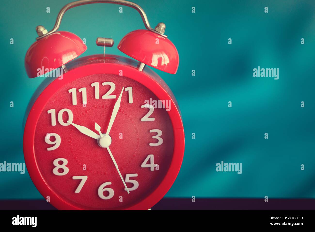 Closeup on clockwise. Face of red Alarm clock at 10 O'clock Stock Photo
