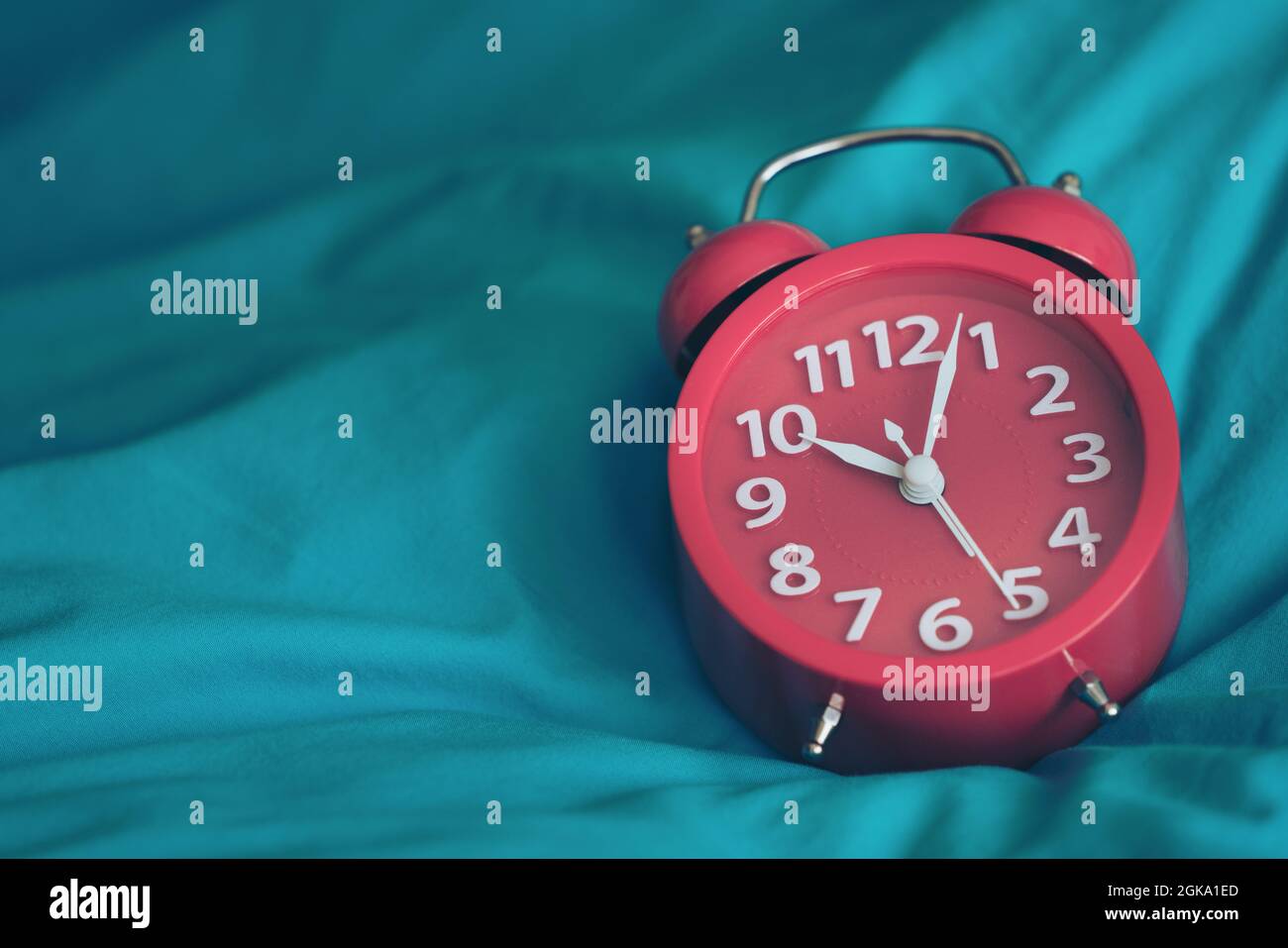 Closeup on clockwise. Face of red Alarm clock at 10 O'clock Stock Photo