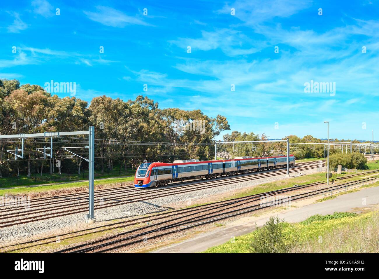 Electric passenger train departing from the Mile End Railway Station and heading to Adelaide city on a bright day Stock Photo