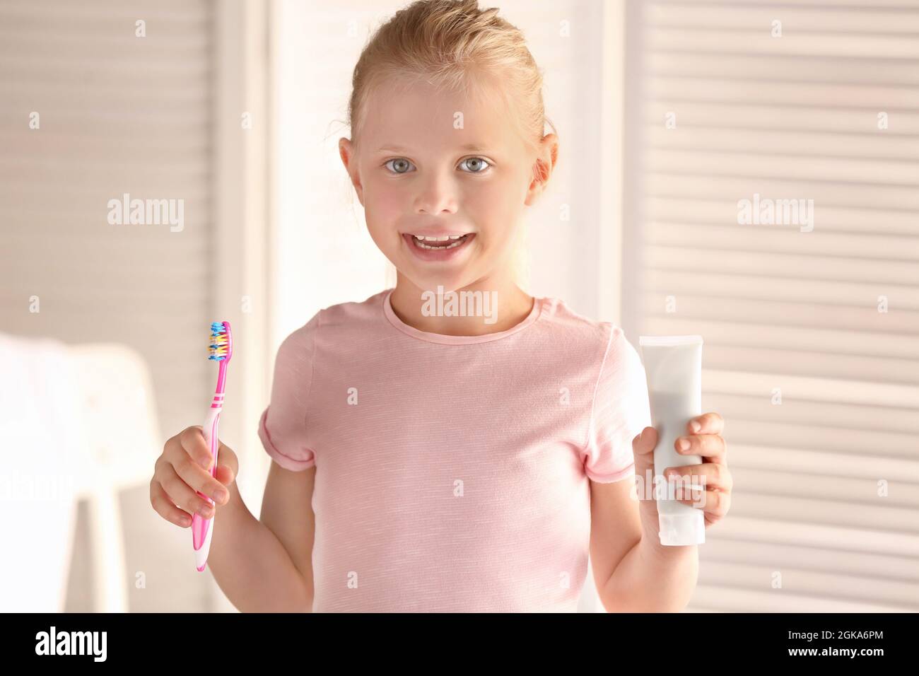 Cute little girl with toothbrush and paste at home. Cleaning teeth