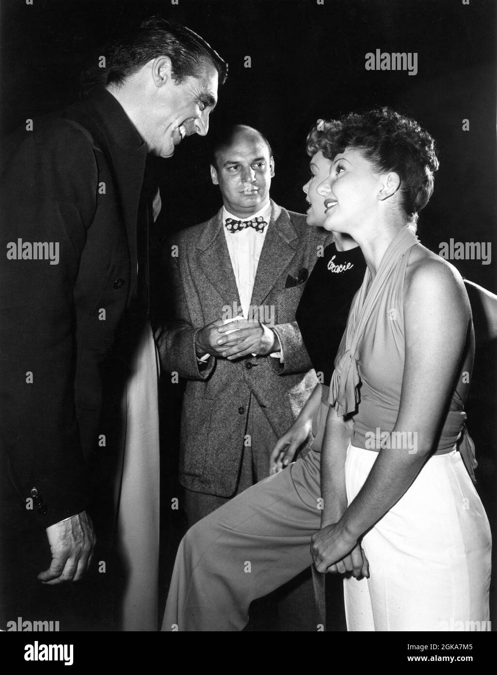 CARY GRANT playing composer Cole Porter JANE WYMAN and MARY MARTIN on set candid during filming of NIGHT AND DAY 1946 director MICHAEL CURTIZ Warner Bros. Stock Photo