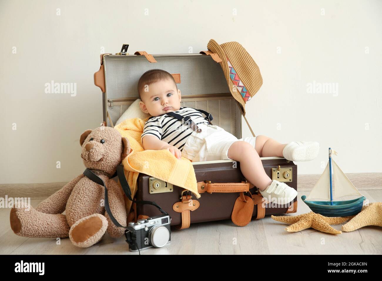 Cute little boy lying in suitcase. Concept of baby holiday Stock Photo