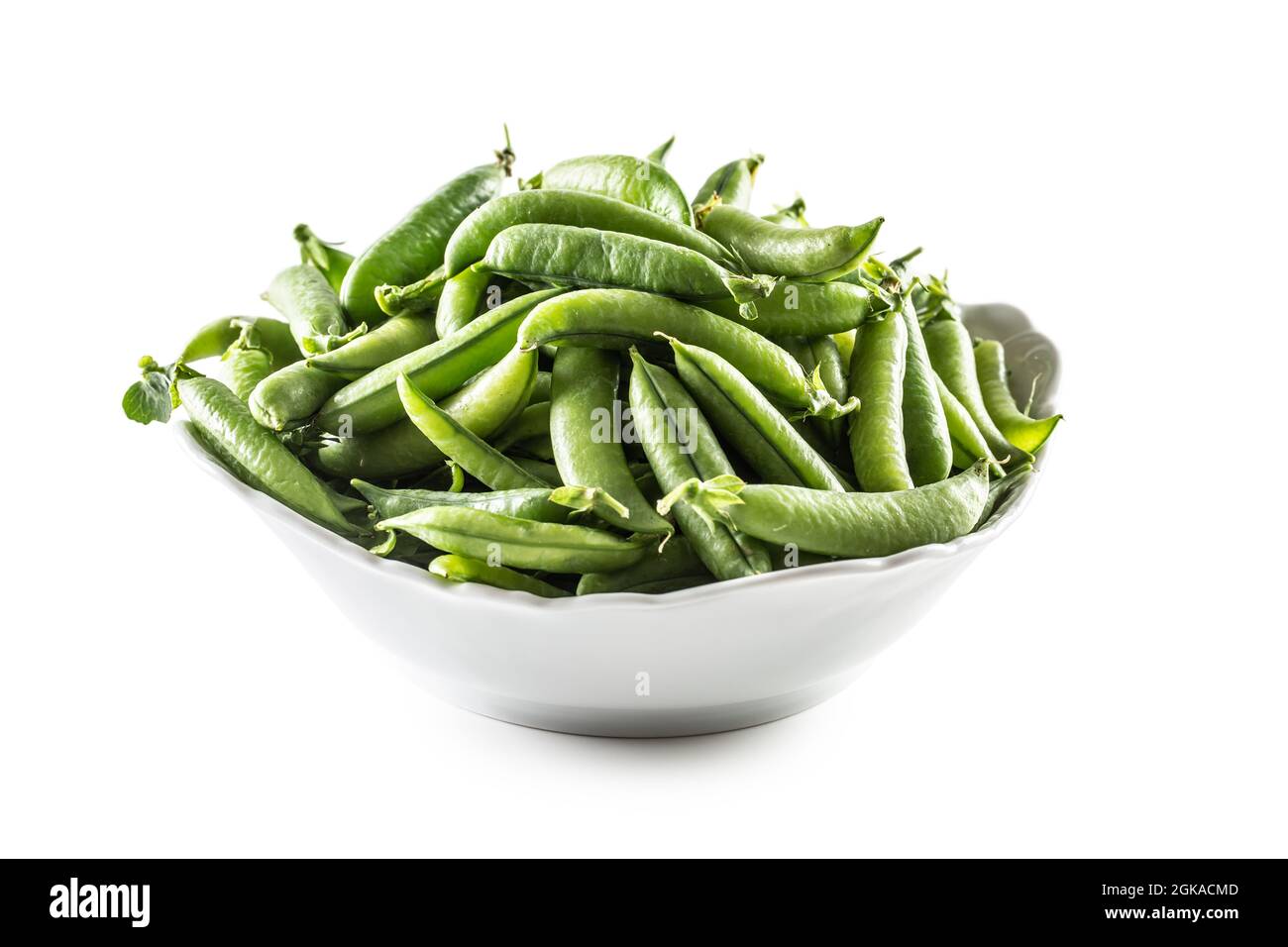Fresh Green pea pods in white bowl isolated on white background. Stock Photo