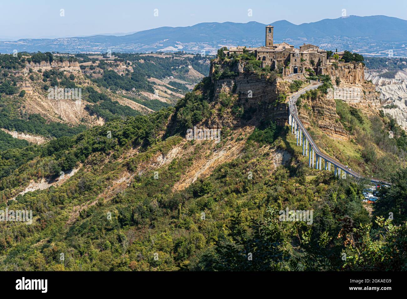 VITERBO ITALY, UK. 13 September, 2021.  Tourists walk on the bridge to Civita di Bagnoregio, a picturesque hilltop village in Italy, is a popular day trip destination from Rome on a hot day. Italian tourism has hit an all-time high during July and August since the according to  the Italian Confederation of Craft Trades and Small and Medium-Sized Enterprises (CNA) with the  rise in travel demand has been attributed to the implementation of the country’s green pass. Credit: amer ghazzal/Alamy Live News Stock Photo
