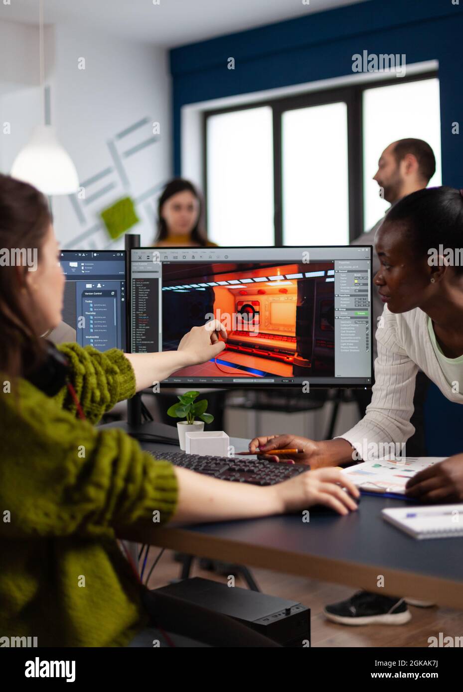 Diverse women game developers creating game interface sitting in startup  creative production company pointing at pc displays. Workers developing  online graphics video games with modern technology Stock Photo - Alamy