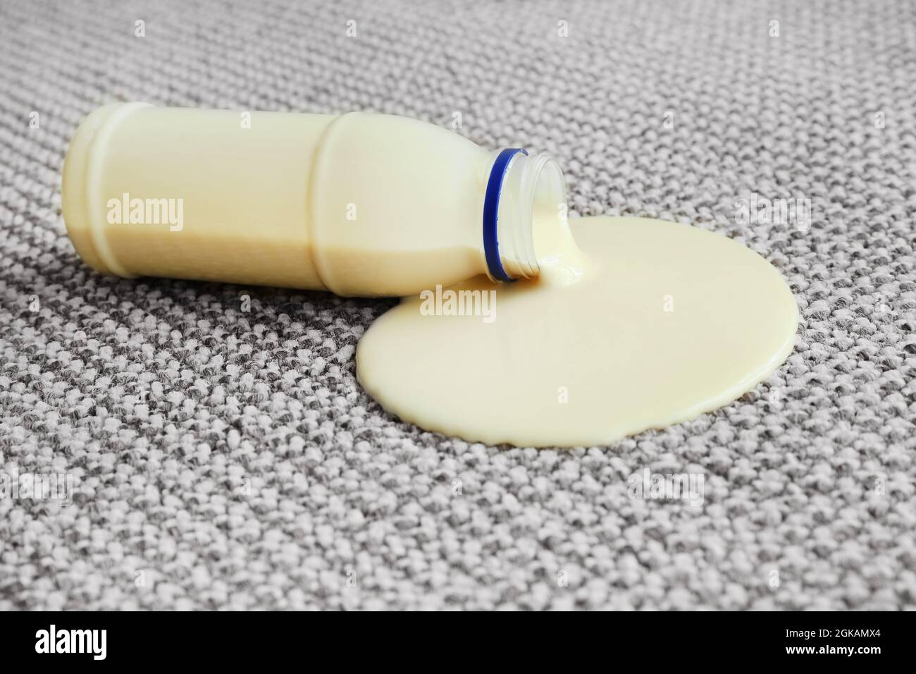 Bottle of yogurt spilled on carpet Stock Photo Alamy