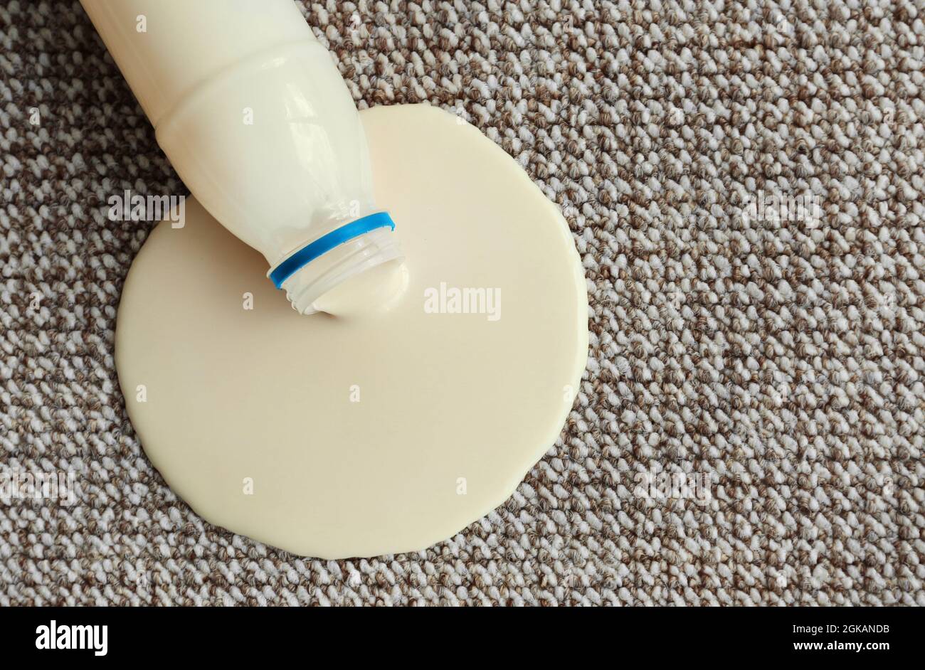 Bottle of yogurt spilled on carpet Stock Photo Alamy