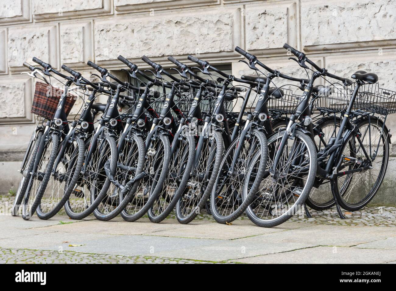 Rental bikes neatly set up in front of a hotel in Berlin Stock Photo