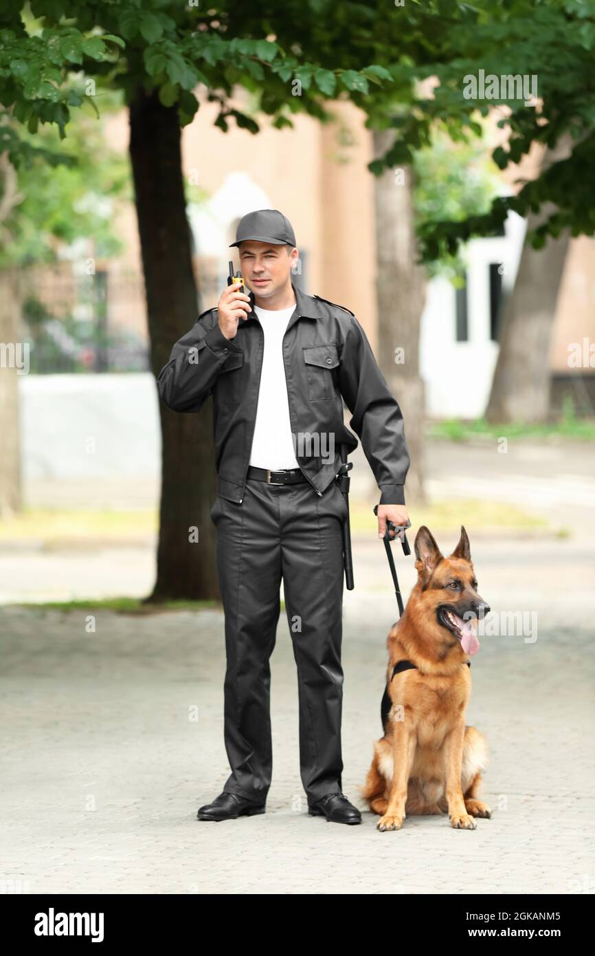 Security guard with dog, outdoors Stock Photo Alamy