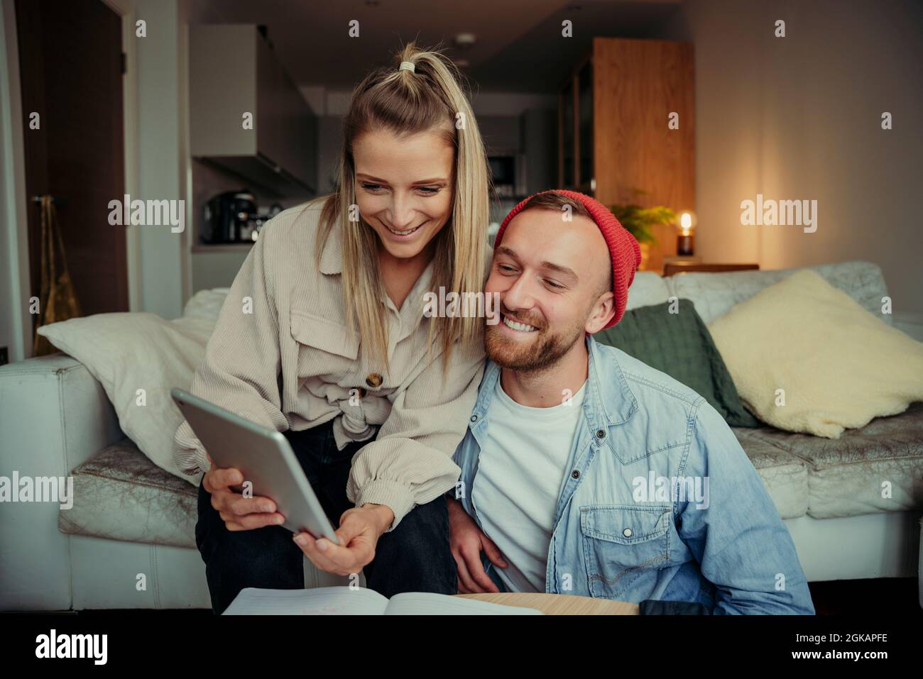 Caucasian happy couple working from home using digital tablet Stock Photo