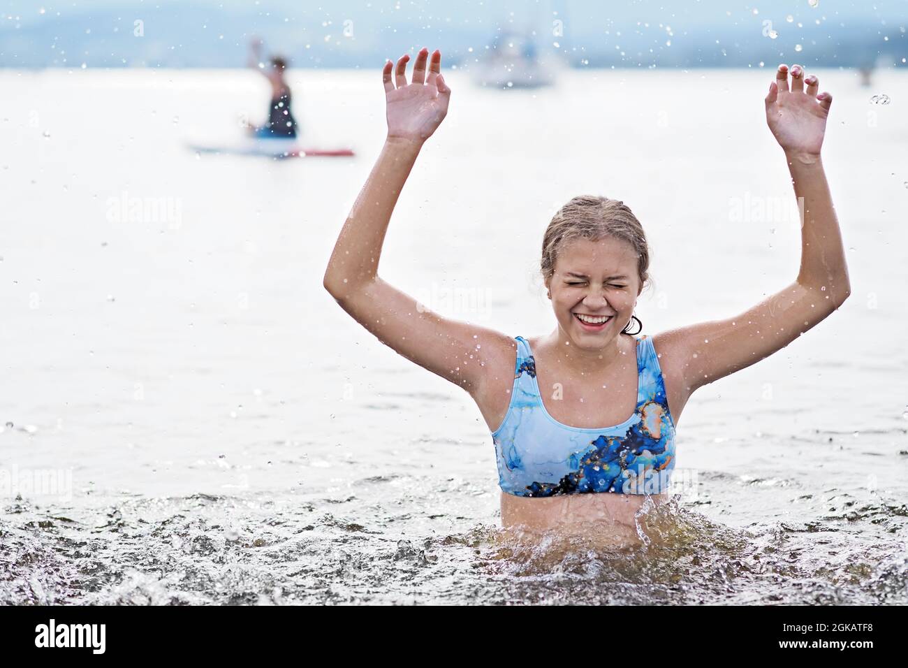 Young girl swims in the lake Stock Photo
