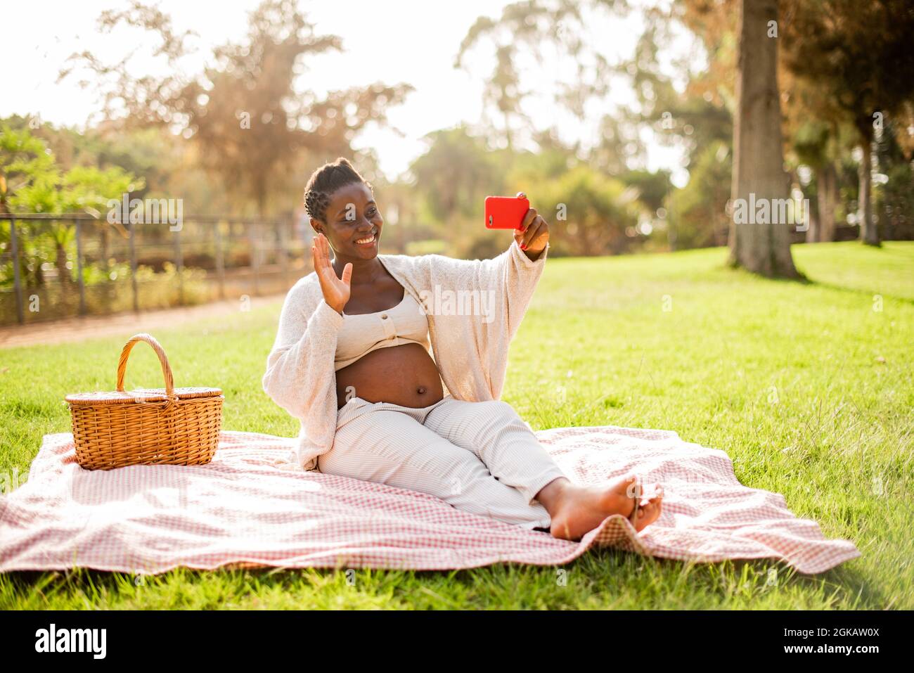 Pregnant African American woman making video call Stock Photo