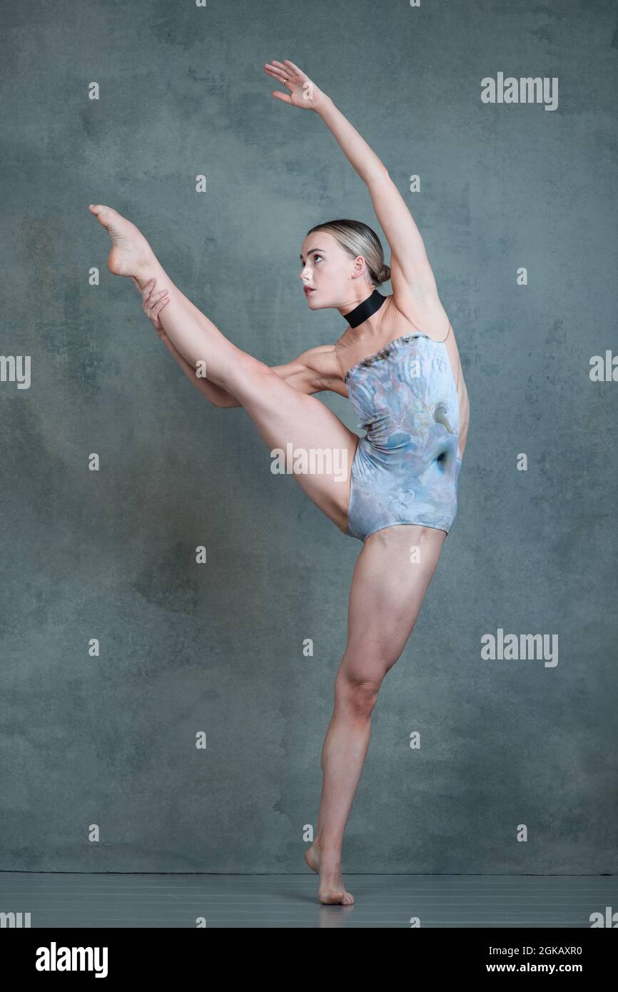 Contemporary dancer in backless leotard in dynamic dance pose Stock Photo