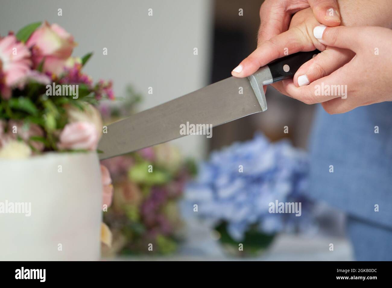 Detail of bride and groom cutting wedding cake after getting married. High quality photo Stock Photo