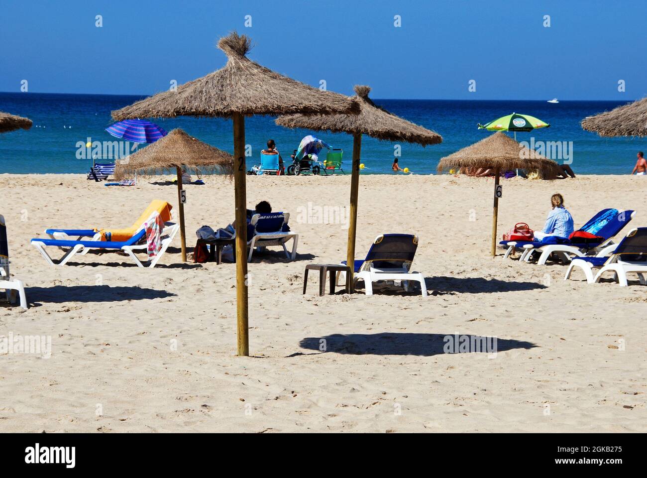 Tourists relaxing on the beach with views out to sea, Zahara de los Atunes, Cadiz Province, Andalusia, Spain. Stock Photo