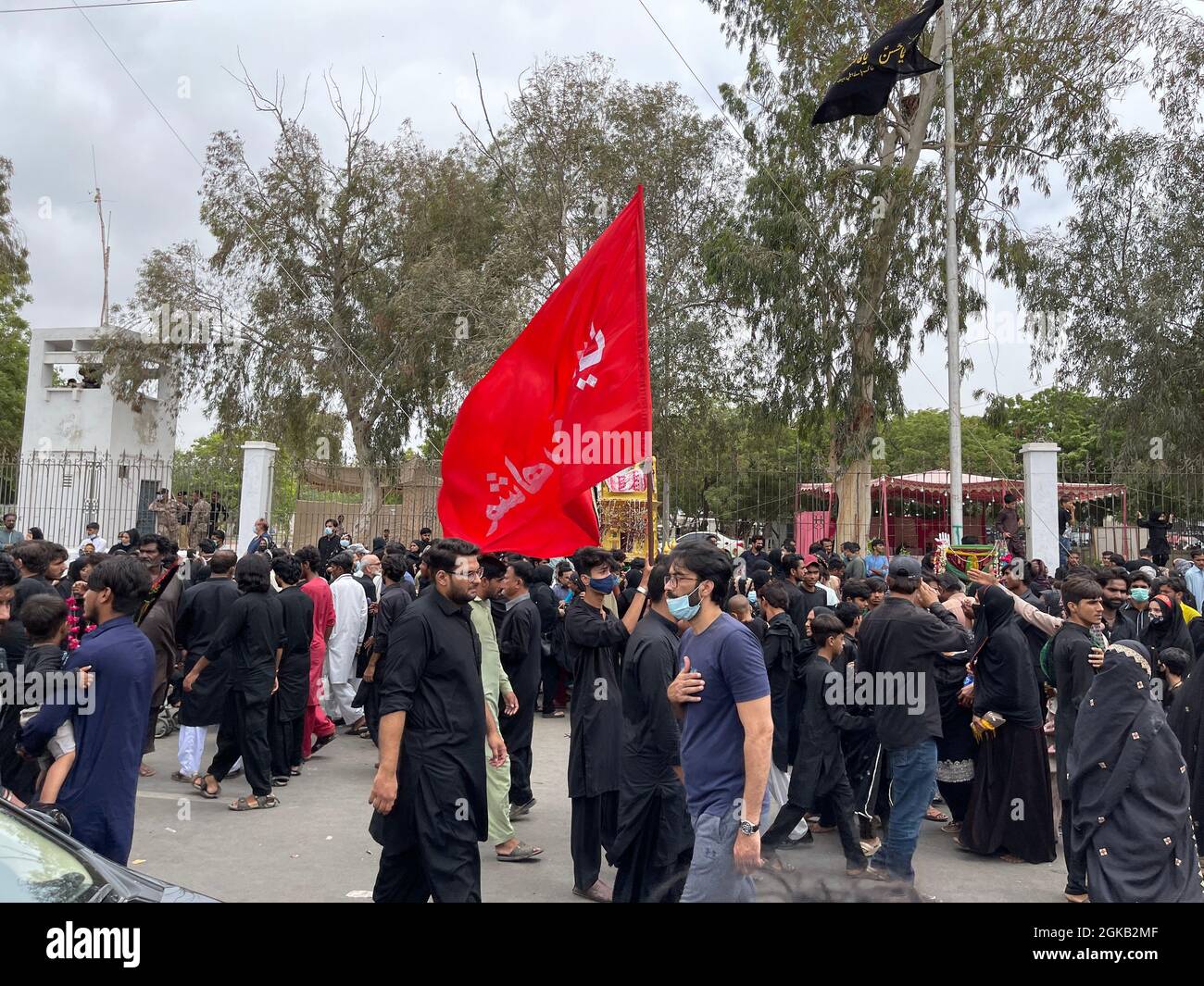 Devotees of Imam Hussain are holding mourning procession in connection of 10th Muharram-ul-Haram, passing through M A jinnah Road Stock Photo