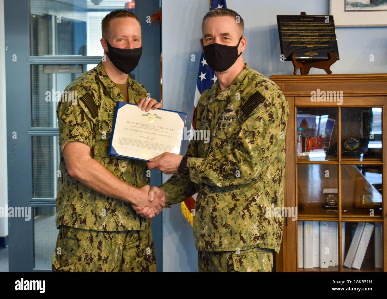 Capt. Steven W. Antcliff, Commanding Officer of the Naval Submarine School, awards Lt. Nicholas H. Biela with the Navy and Marine Corps Commendation Medal at Naval Submarine Base New London, Groton CT, on March 1, 2021 upon successful completion of his tour as an instructor at the Submarine Officer Basic Course. He was responsible for training and preparing junior officers for operational submarine service. Stock Photo