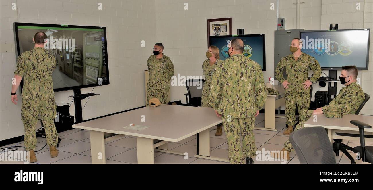 210301-N-KJ380-1013 PENSACOLA, Fla. (March 1, 2021) - Naval Information Forces (NAVIFOR) Force Master Chief David Twiford (far right) receives a demonstration of the Multipurpose Reconfigurable Training System 3D® (MRTS 3D®) technology training device with staff at Information Warfare Training Command (IWTC) Corry Station. Twiford visited the Center for Information Warfare Training (CIWT) and IWTC Corry Station for a familiarization brief and tour onboard Naval Air Station Pensacola Corry Station, Pensacola, Florida. The visit offered an opportunity to update him on CIWT / IWTC Corry Station t Stock Photo