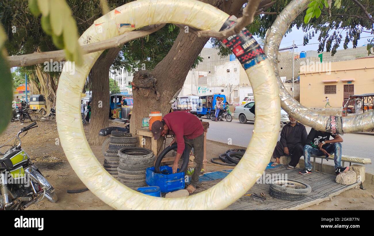 Bike puncture stall at Korangi Road Stock Photo Alamy