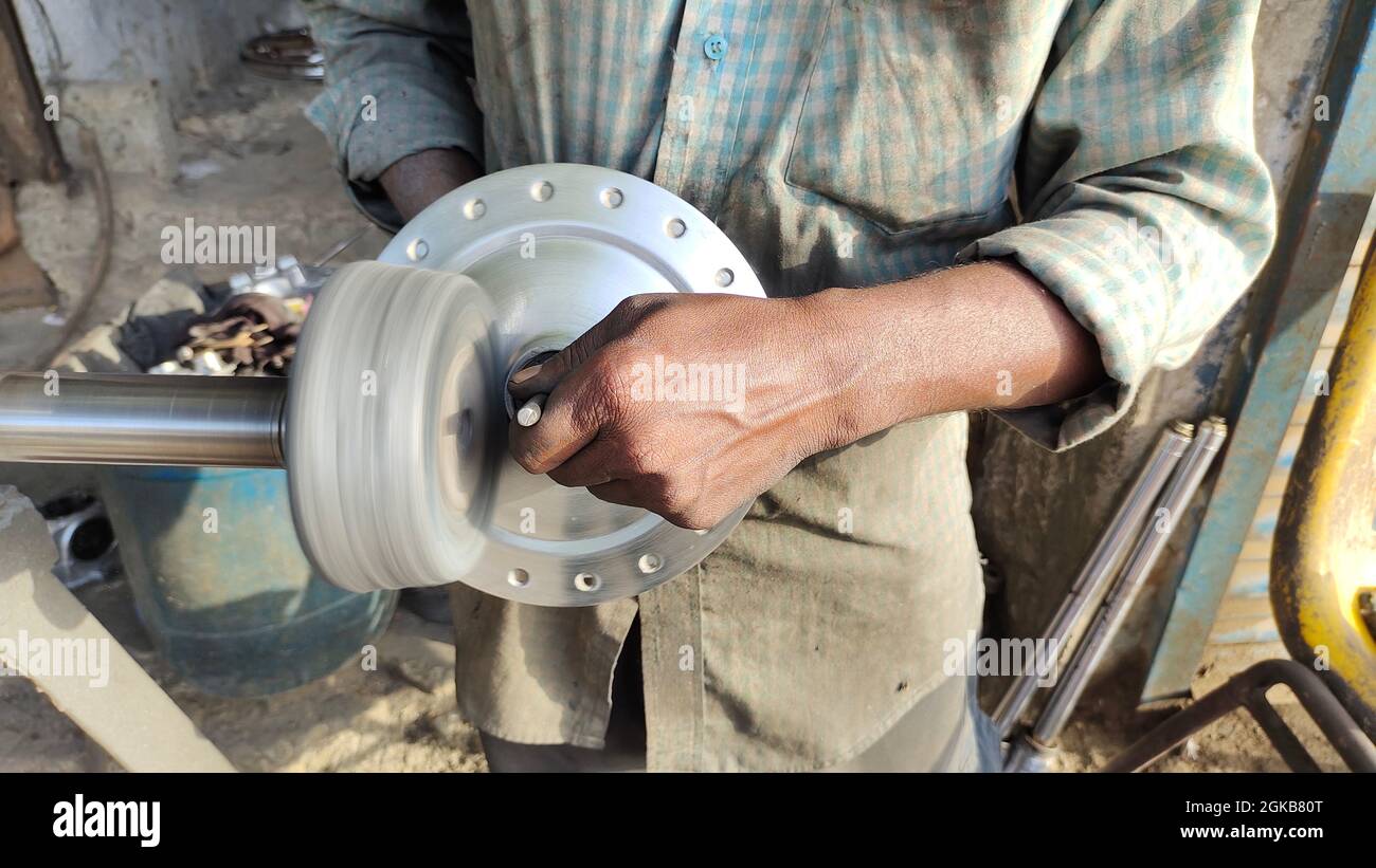 Bike wheel Brake Drum, polishing concept. Professional male auto