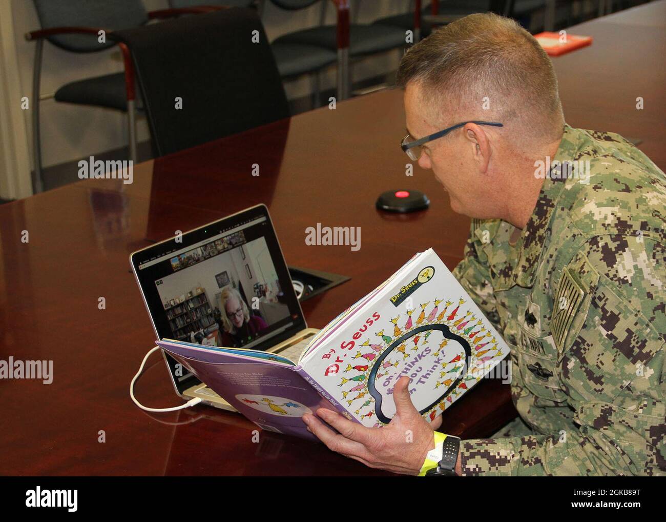 210302-N-HC520-001 NORFOLK, Va. (March 2, 2021) Capt. Tres Meek, commanding officer of NAVFAC Mid-Atlantic, reads to a virtual classroom of students from Saint Patrick Catholic School in Norfolk, Va. as part of Read Across America Day, Mar. 2. The day was established in 1998 by the National Education Association (NEA) as a way to encourage school-aged children to read more, and is often recognized by special programs, ceremonies and activities across the country. Stock Photo