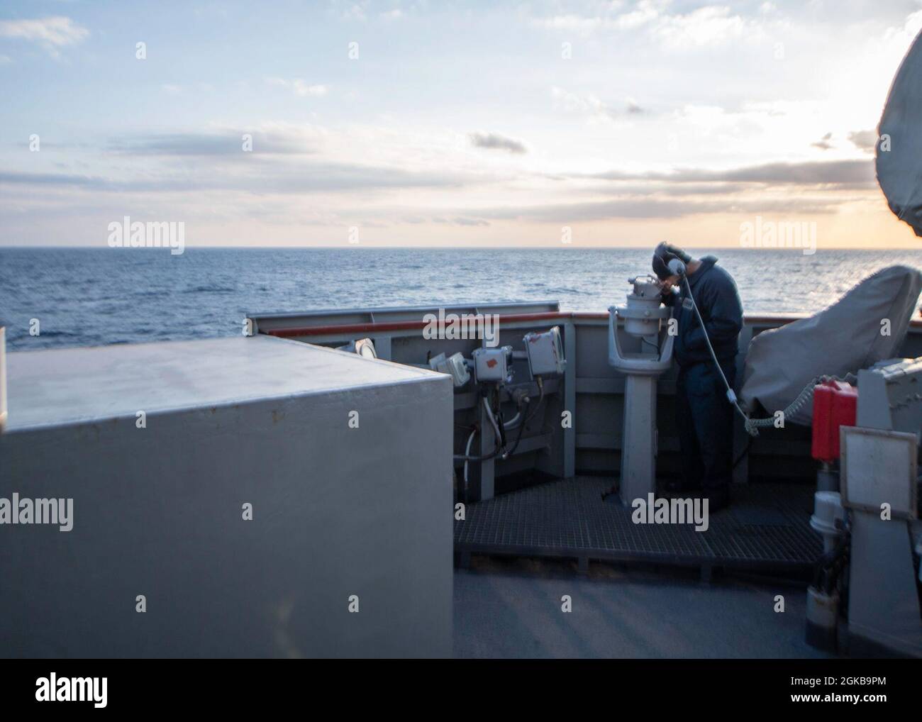 210303-N-RG171-0043 MEDITERRANEAN SEA (Mar. 3, 2021) Seaman Onyx Martinezmaldinado looks through a telescopic alidade on the bridge of the Arleigh Burke-class guided-missile destroyer USS Donald Cook (DDG 75), Mar. 3, 2021. Donald Cook, forward-deployed to Rota, Spain, is on patrol in the U.S. Sixth Fleet area of operations in support of regional allies and partners and U.S. national security in Europe and Africa. Stock Photo