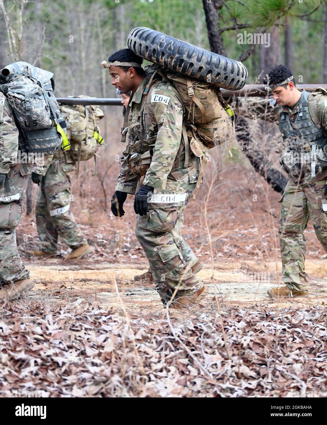 Civil Affairs candidates at the U.S. Army John F. Kennedy Special Warfare Center and School carry tires while participating in a team-building event during Civil Affairs Assessment and Selection (CAAS) at Camp Mackall, North Carolina, March 2, 2021. The candidates who attended the 10-day course were evaluated for trainability and suitability to attend the Civil Affairs Team Leader or the Civil Affairs Noncommissioned Officer pathway and for the attributes and competencies required to be a member of a Civil Affairs Team. Stock Photo