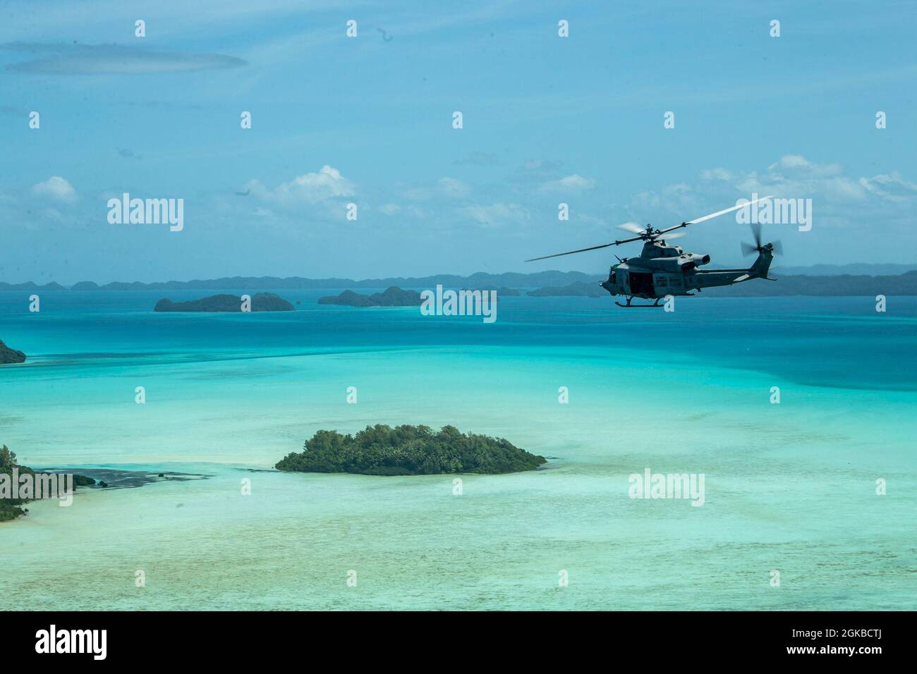 A U.S. Marine Corps UH-1Y Huey with Marine Medium Tiltrotor Squadron 262 (Reinforced), 31st Marine Expeditionary Unit (MEU), flies above Palau after departing from USS New Orleans (LPD 18) on its way to the island of Peleliu, March 3, 2021. The 31st MEU is operating aboard ships of the Amphibious Squadron 11 in the 7th fleet area of operations to enhance interoperability with allies and partners and serve as a ready response force to defend peace and stability in the Indo-Pacific region. Stock Photo
